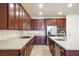 Gourmet kitchen boasts stainless steel appliances, granite countertops and center island at 2824 Shadows Edge Ct, Henderson, NV 89052