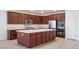 Well-lit kitchen features stainless steel appliances, granite countertops and a spacious center island at 2824 Shadows Edge Ct, Henderson, NV 89052