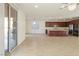 Open-concept kitchen with stainless steel appliances, dark cabinets, and tile flooring, ideal for modern living at 2824 Shadows Edge Ct, Henderson, NV 89052