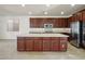 Large kitchen offers stainless steel appliances, granite countertops and center island with bar stool seating at 2824 Shadows Edge Ct, Henderson, NV 89052