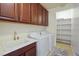 Convenient laundry room with modern washer and dryer, sink and built-in storage, perfect for organization at 2824 Shadows Edge Ct, Henderson, NV 89052