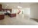 Spacious living room features tile floors, stairs, kitchen with granite island and a stylish chandelier at 2824 Shadows Edge Ct, Henderson, NV 89052