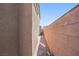 Narrow side yard with brick paver walkway and block wall at 2824 Shadows Edge Ct, Henderson, NV 89052