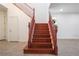 Elegant wooden staircase with contrasting wood flooring adds charm to this home at 2824 Shadows Edge Ct, Henderson, NV 89052