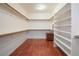 Spacious walk-in closet with custom shelving and wood floors, providing ample storage at 2824 Shadows Edge Ct, Henderson, NV 89052