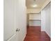 Spacious walk-in closet with custom shelving and wood floors, providing ample storage at 2824 Shadows Edge Ct, Henderson, NV 89052