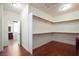 Spacious walk-in closet with custom shelving and wood floors, providing ample storage at 2824 Shadows Edge Ct, Henderson, NV 89052