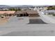 Aerial view of a well-maintained home with a spacious driveway and manicured landscaping at 3080 S Prairie Ave, Pahrump, NV 89048