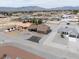 Wide aerial view showcasing a home with desert landscaping and mountain views in the distance at 3080 S Prairie Ave, Pahrump, NV 89048