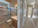 Well-lit bathroom with glass enclosed shower, modern vanity, and wood-look flooring at 3080 S Prairie Ave, Pahrump, NV 89048