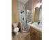 Bathroom featuring a tile shower with a glass door and a vanity with a modern sink at 3080 S Prairie Ave, Pahrump, NV 89048
