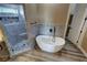 Stunning bathroom featuring a soaking tub and a separate tiled shower with hexagon tile flooring at 3080 S Prairie Ave, Pahrump, NV 89048