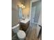 Cozy bathroom with modern vanity, mirror, and wood-look floors at 3080 S Prairie Ave, Pahrump, NV 89048