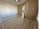 Simple bedroom with wood floors, a ceiling fan, and a view into the hallway at 3080 S Prairie Ave, Pahrump, NV 89048