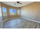 Spacious bedroom featuring wood-look flooring and multiple windows at 3080 S Prairie Ave, Pahrump, NV 89048