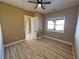 Bright bedroom with wood floors, ceiling fan, and a view of the outside at 3080 S Prairie Ave, Pahrump, NV 89048