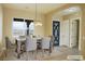 Dining room with modern table setting and view of front door, illuminated by stylish lighting at 3080 S Prairie Ave, Pahrump, NV 89048