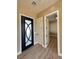Entryway featuring a modern front door, wood floors, and access to other rooms at 3080 S Prairie Ave, Pahrump, NV 89048