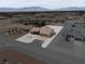Stunning home exterior with a wide driveway and desert landscaping at 3080 S Prairie Ave, Pahrump, NV 89048