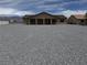Single-story home with a spacious yard and covered patio, perfect for outdoor living at 3080 S Prairie Ave, Pahrump, NV 89048