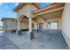 Inviting covered front entry with decorative columns, stone accents, and a modern front door at 3080 S Prairie Ave, Pahrump, NV 89048