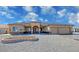 Beautiful single-story home with stucco exterior, stone accents, three-car garage, and desert landscaping at 3080 S Prairie Ave, Pahrump, NV 89048