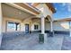 Spacious front porch featuring stone columns, stylish lighting, and a modern front door at 3080 S Prairie Ave, Pahrump, NV 89048