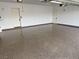 Clean three-car garage with a sealed floor and white walls at 3080 S Prairie Ave, Pahrump, NV 89048