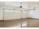 A bright three-car garage featuring white doors and epoxy floors at 3080 S Prairie Ave, Pahrump, NV 89048