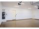 Spacious three car garage with epoxy flooring, white walls and modern doors at 3080 S Prairie Ave, Pahrump, NV 89048
