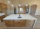 Spacious kitchen island with granite countertops, sink, custom cabinetry, and pendant lights above at 3080 S Prairie Ave, Pahrump, NV 89048
