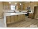Virtually staged kitchen featuring an island with sink and seating at 3080 S Prairie Ave, Pahrump, NV 89048