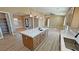 Gourmet kitchen features center island with sink and seating area, pendant lights and open floor plan at 3080 S Prairie Ave, Pahrump, NV 89048