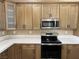 Bright kitchen with modern appliances, sleek countertops, and wood grain cabinetry at 3080 S Prairie Ave, Pahrump, NV 89048