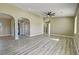 Spacious living room with wood-look flooring, recessed lighting, and neutral paint at 3080 S Prairie Ave, Pahrump, NV 89048