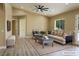Virtually staged living room showing neutral decor and wood-look floors at 3080 S Prairie Ave, Pahrump, NV 89048