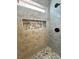 Stylish shower with gray tiling, mosaic accents, and a niche for toiletries at 3080 S Prairie Ave, Pahrump, NV 89048