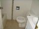 Small bathroom with tiled walls, tile flooring, and a standard toilet, sink and tub at 313 View Dr, Las Vegas, NV 89107