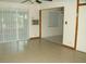 Open concept living room with tile flooring, ceiling fan, and a sliding glass door to the back at 313 View Dr, Las Vegas, NV 89107