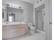 Bright bathroom featuring double sink vanity, mirrored wall, and a glass shower at 3604 Lisandro St # 204, Las Vegas, NV 89108