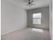 Bright bedroom with neutral carpeting, ceiling fan, and window providing natural light at 3604 Lisandro St # 204, Las Vegas, NV 89108