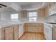 Bright kitchen featuring light wood cabinets, white appliances, and a convenient breakfast bar at 3604 Lisandro St # 204, Las Vegas, NV 89108
