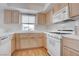 Well-lit kitchen featuring light wood cabinets, white appliances, and a functional design at 3604 Lisandro St # 204, Las Vegas, NV 89108
