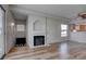 Living room featuring a fireplace and wood-look flooring, adjacent to a kitchen with natural light at 3604 Lisandro St # 204, Las Vegas, NV 89108