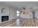 Open floor plan with fireplace, wood-look flooring, and bright kitchen with natural wood cabinets at 3604 Lisandro St # 204, Las Vegas, NV 89108