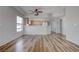 Bright, open-concept living room featuring wood-look flooring and natural light, complemented by neutral walls at 3604 Lisandro St # 204, Las Vegas, NV 89108