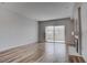 Open living space with wood-look floors, fireplace, and sliding doors to a balcony at 3604 Lisandro St # 204, Las Vegas, NV 89108