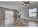 Bright living room featuring a fireplace, sliding glass doors to a balcony and wood-look flooring at 3604 Lisandro St # 204, Las Vegas, NV 89108