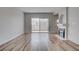 Spacious living room with fireplace, wood-look floors, and access to a bright, airy balcony at 3604 Lisandro St # 204, Las Vegas, NV 89108