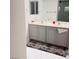Bathroom showcasing a double sink vanity with gray cabinets and stylish marble flooring at 3634 Surfboard Ct, Las Vegas, NV 89147
